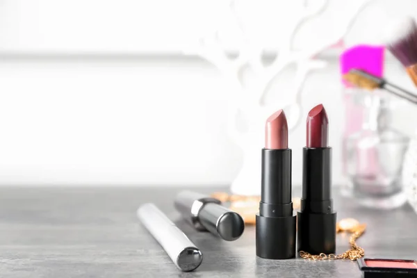 Different Lipsticks Other Cosmetics Grey Table — Stock Photo, Image