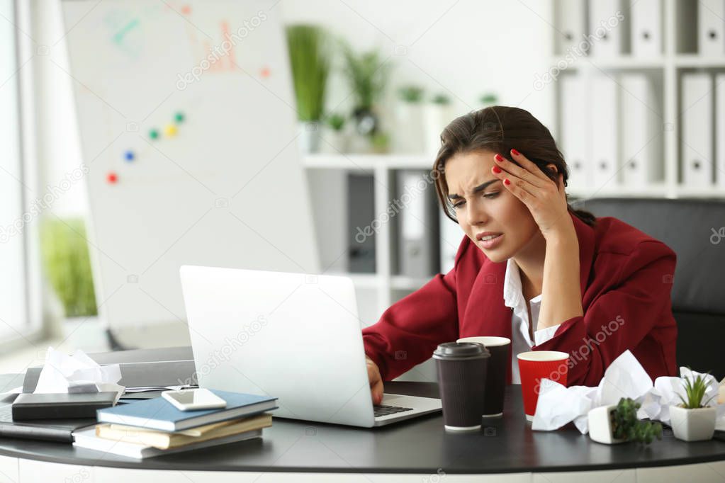 Tired businesswoman working in office