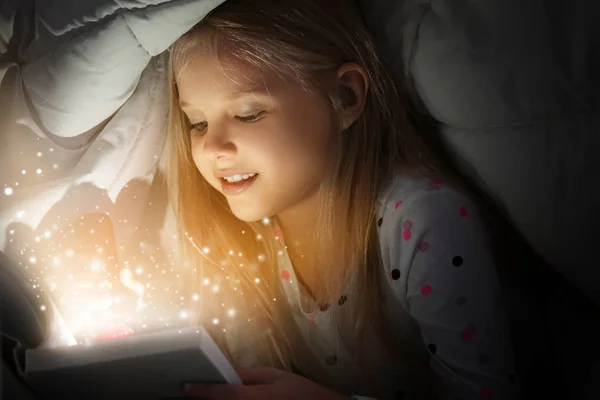 Cute Little Girl Reading Magic Book Bed Blanket — Stock Photo, Image
