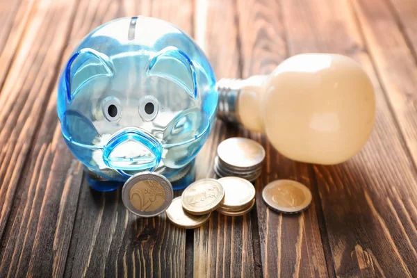 Piggy Bank Coins Light Bulb Wooden Background Electricity Saving Concept — Stock Photo, Image