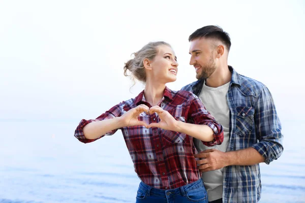 Cute Young Couple Making Heart Hands Sea Shore — Stock Photo, Image