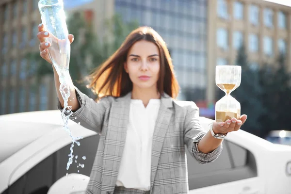 Young Businesswoman Holding Empty Bottle Hourglass Outdoors Time Management Concept — Stock Photo, Image