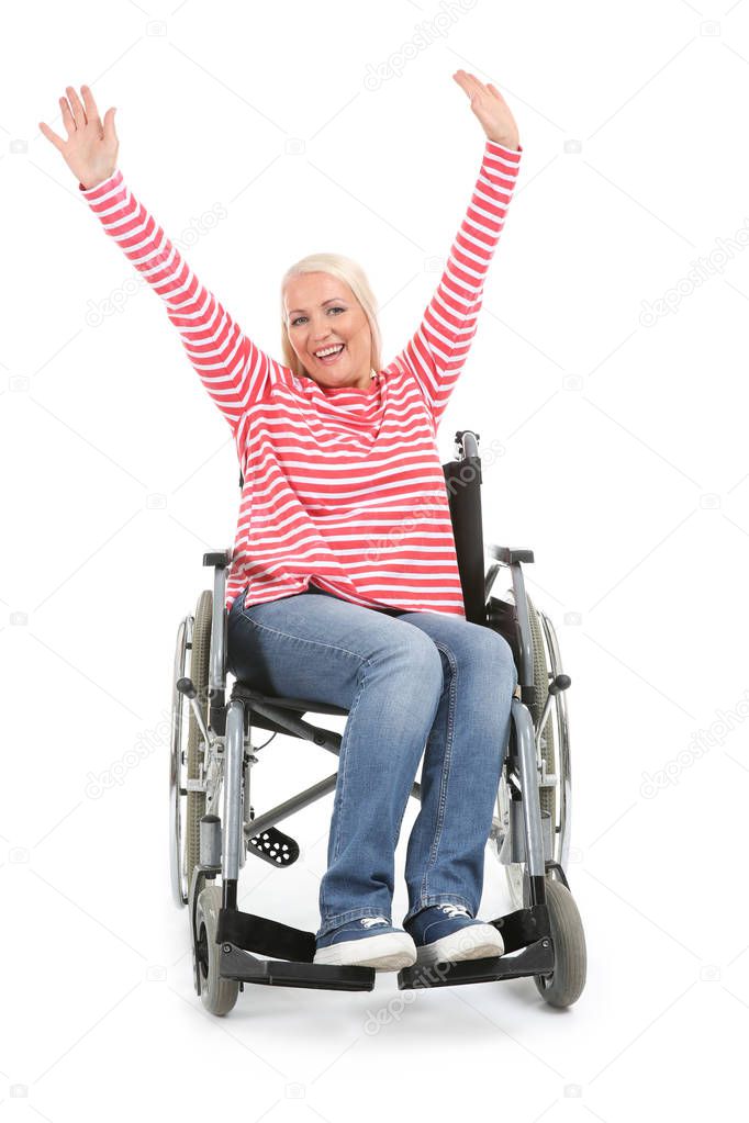 Happy mature woman sitting in wheelchair on white background