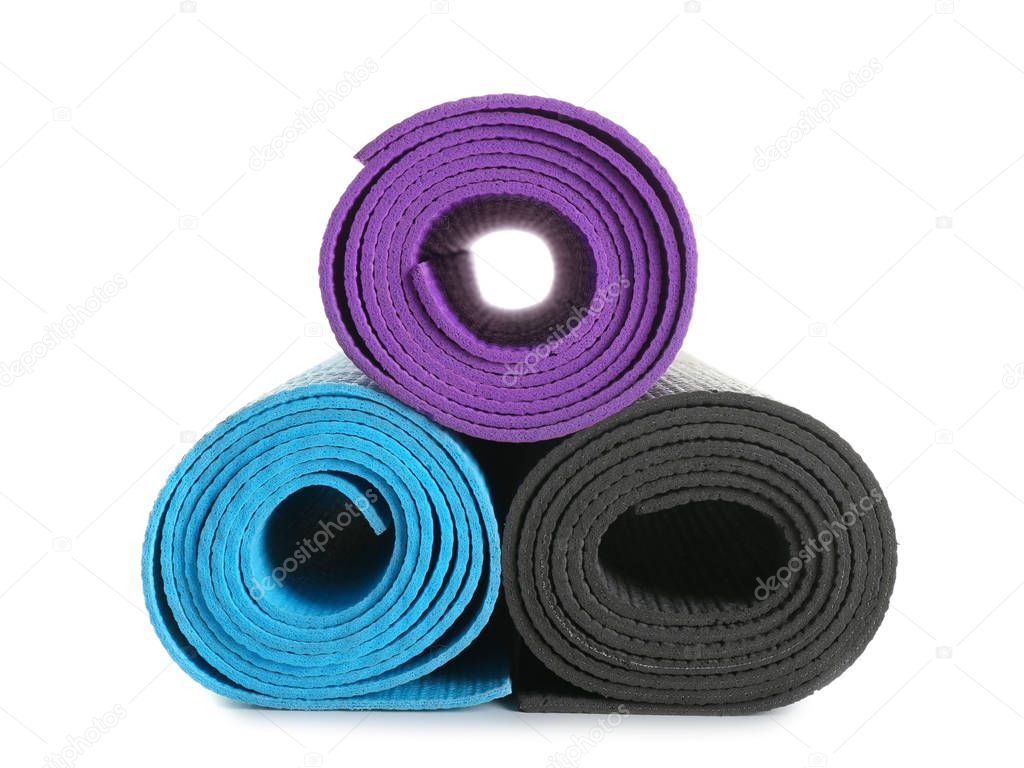 Different yoga mats on white background