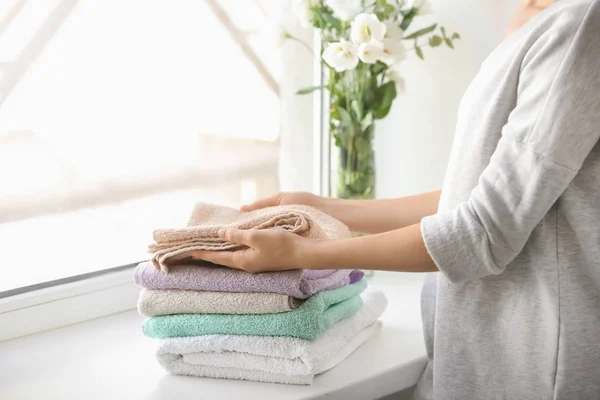 Woman Stacking Clean Towels Windowsill — Stock Photo, Image