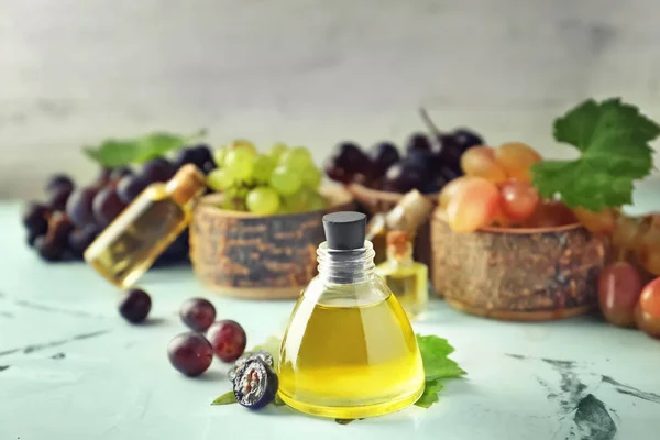 Bottle with grape seed oil on table