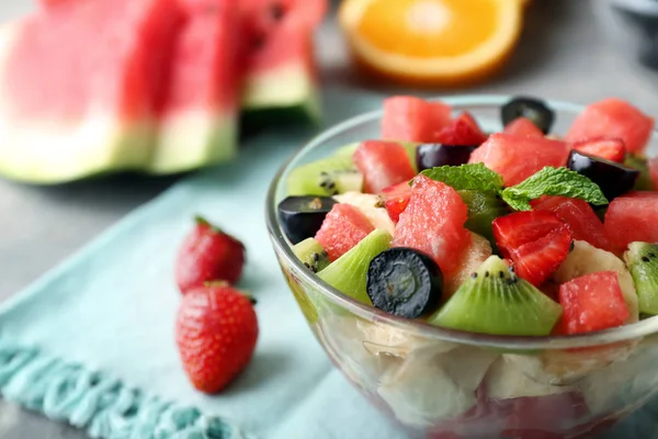 Bowl with delicious watermelon salad on table