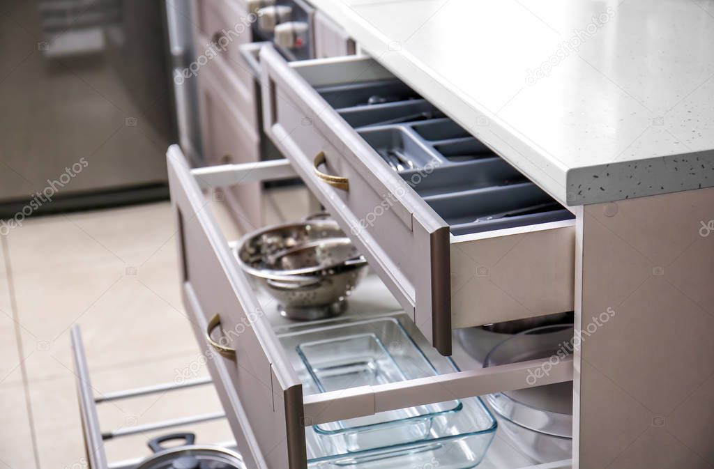Set of clean kitchenware in drawers