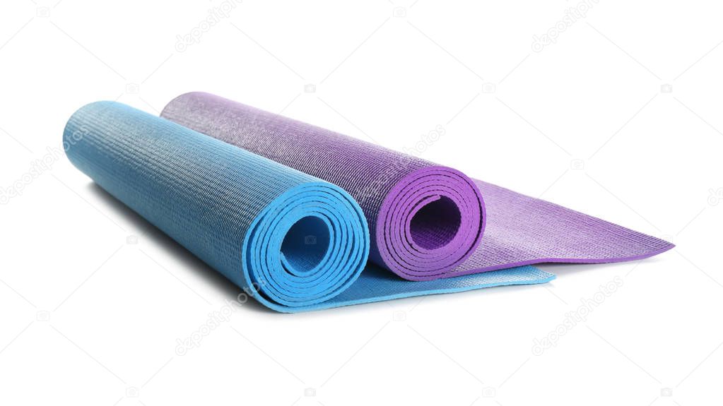 Different yoga mats on white background