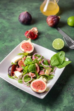 Plaka renk tablosu üzerinde lezzetli incirli salata ile