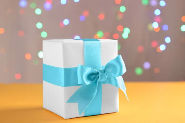 Gift Box Blue Ribbon Color Table Blurred Lights — Stock Photo, Image