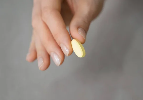 Woman Holding Pill Grey Background Closeup — Stock Photo, Image