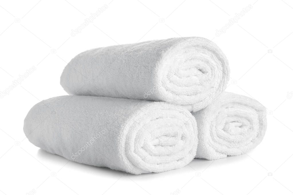 Rolled clean soft towels on white background