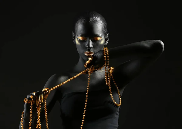 Beautiful Woman Black Golden Paint Her Body Holding Beads Dark — Stock Photo, Image