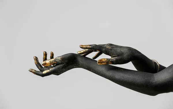 Hands Woman Black Golden Paint Her Body Light Background — Stock Photo, Image