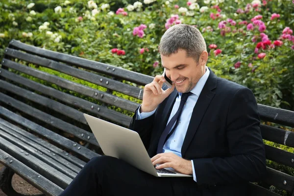 Businessman Laptop Talking Mobile Phone While Sitting Bench Outdoors — Stock Photo, Image