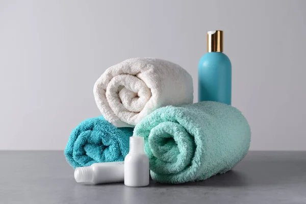 Rolled Clean Towels Cosmetics Grey Table — Stock Photo, Image