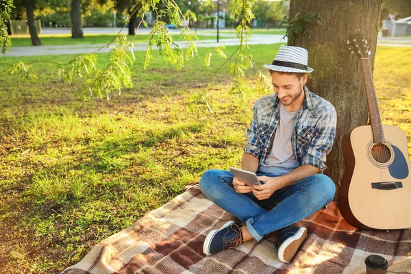 Handsome Young Man Tablet Resting Plaid Park — Stock Photo, Image