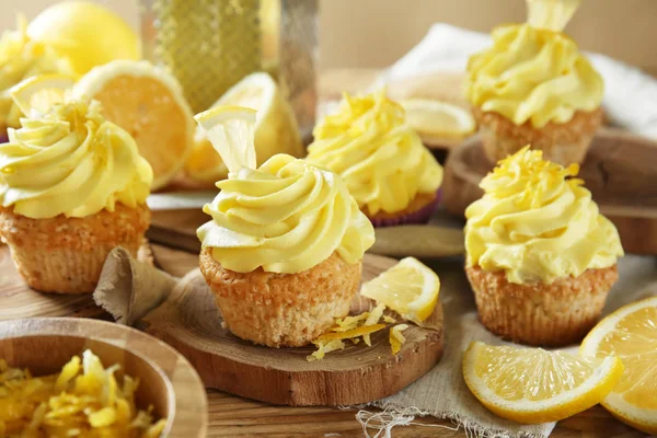 Delicious lemon cupcakes on wooden table