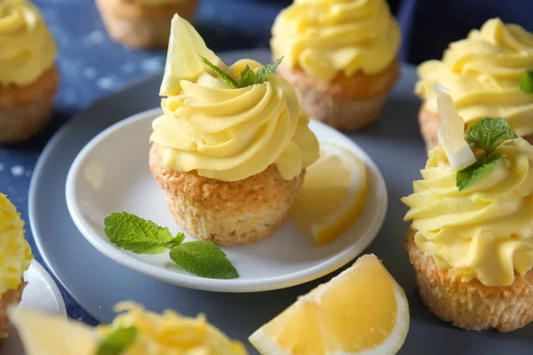 Delicious lemon cupcakes on plate, closeup