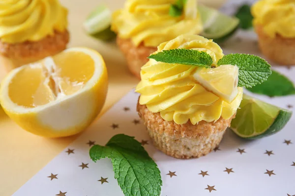 Delicious lemon cupcakes on table