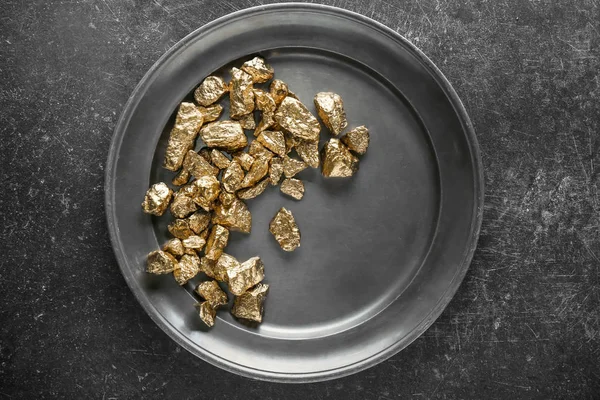 Gold nuggets on metal plate