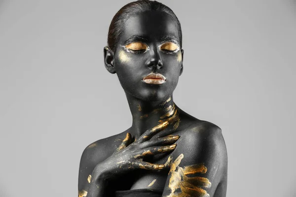 Hermosa Mujer Con Pintura Negra Dorada Cuerpo Sobre Fondo Claro — Foto de Stock