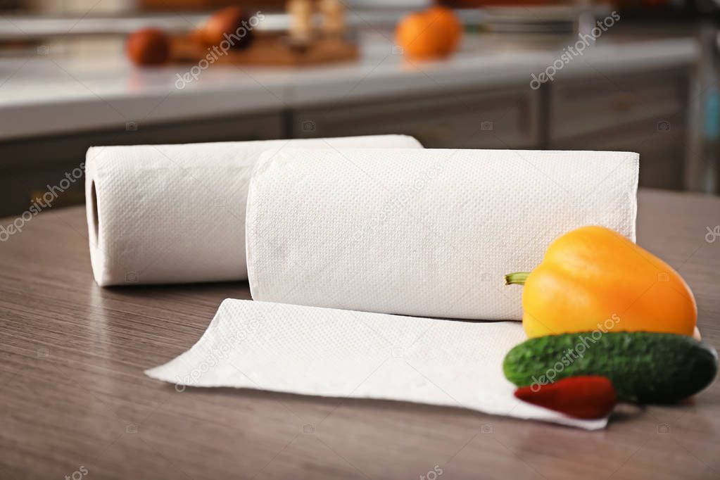 Rolls of paper towels with vegetables on kitchen table