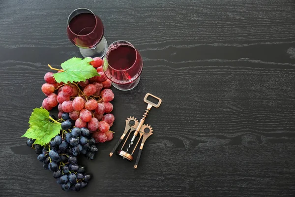 Glasses Red Wine Bottle Opener Ripe Grapes Dark Wooden Table — Stock Photo, Image