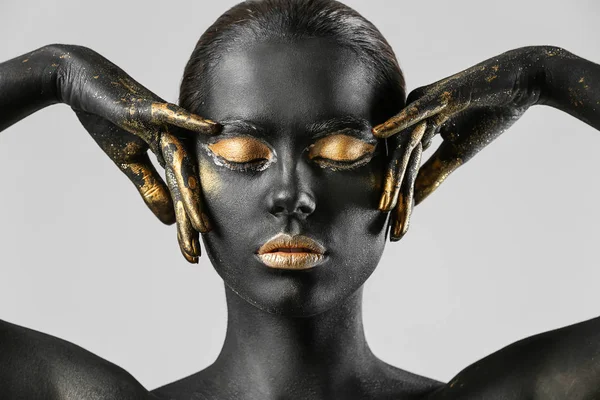 Beautiful Woman Black Golden Paint Her Body Light Background — Stock Photo, Image