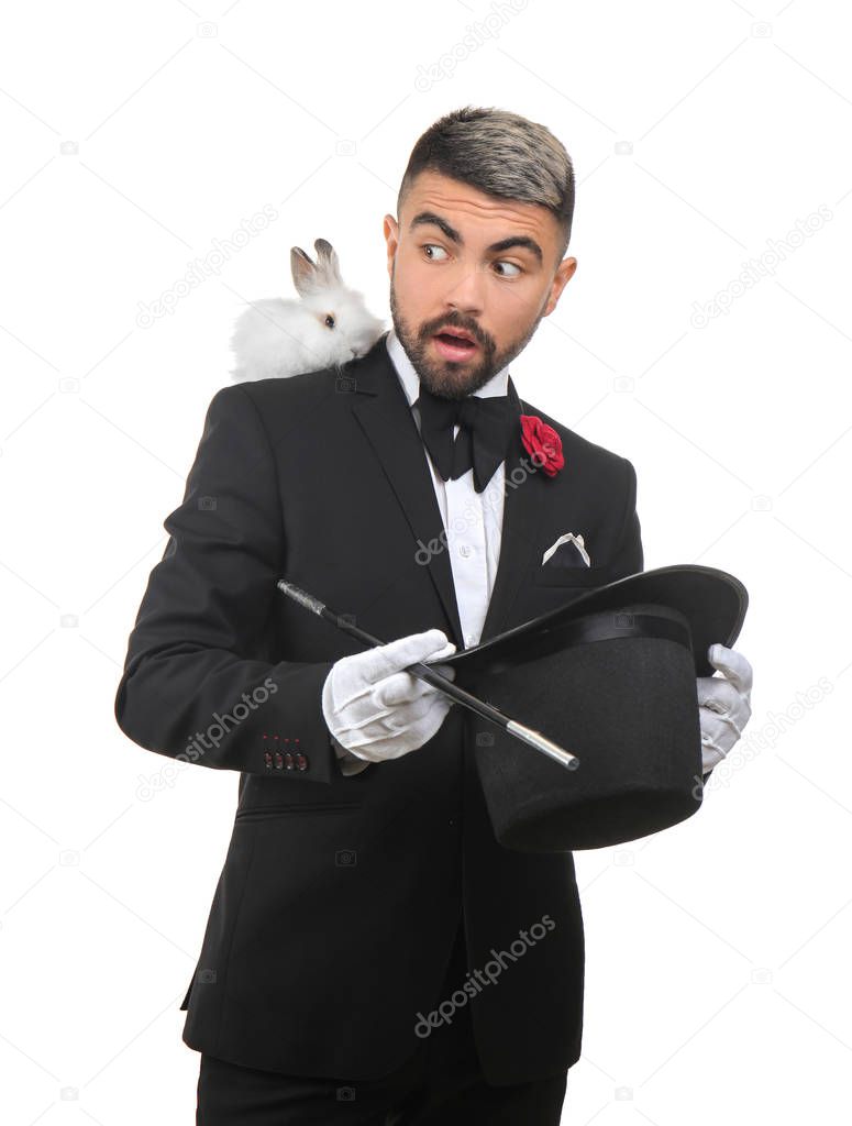 Male magician showing tricks on white background