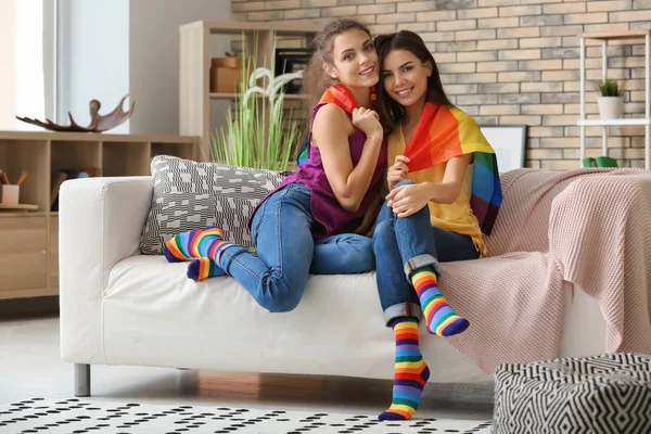 Happy Young Lesbian Couple Rainbow Flag Home — Stock Photo, Image