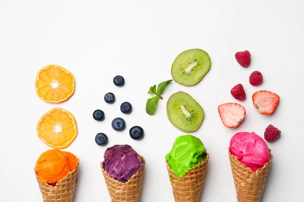 华夫饼锥与美味的颜色冰淇淋 水果和浆果在白色背景 — 图库照片