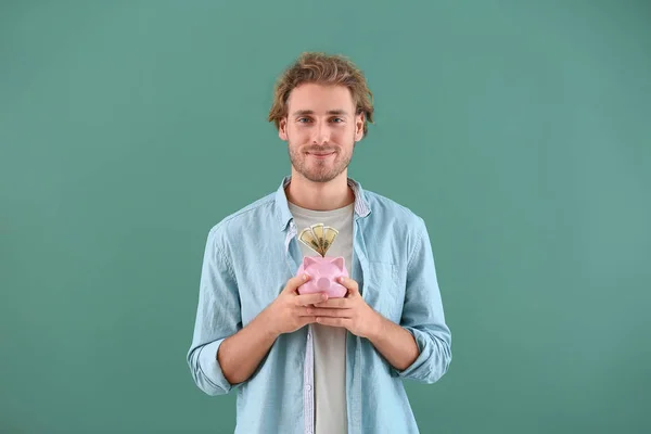 Handsome Man Piggy Bank Color Background — Stock Photo, Image