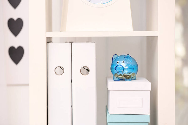 Cute piggy bank with coins on white box