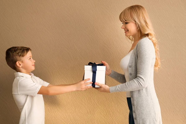 Cute Little Boy Giving His Mother Gift Box Color Background — Stock Photo, Image