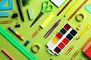 Composition with different school stationery on color background clipart