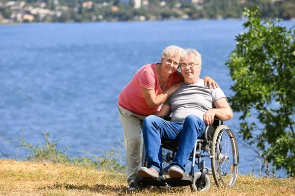 Senior Man Wheelchair His Wife River — Stock Photo, Image