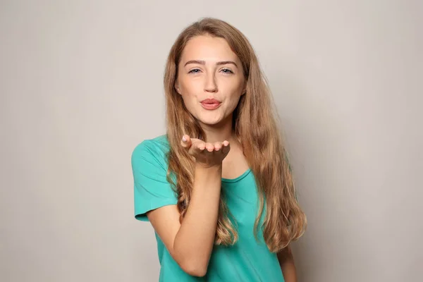 Portrait Beautiful Young Woman Blowing Kiss Light Background — Stock Photo, Image