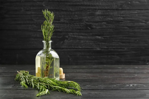 Glass Bottle Fresh Aromatic Rosemary Dark Wooden Table — Stock Photo, Image