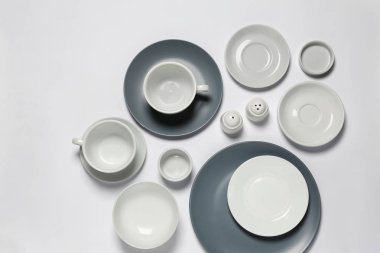 Set of clean tableware on white background clipart