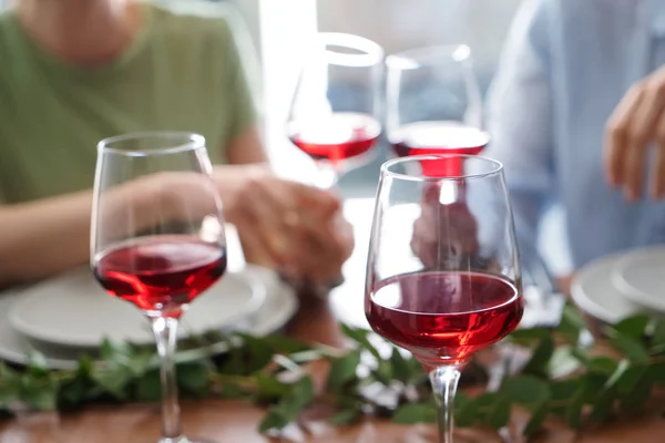 Glasses of red wine on table set for party
