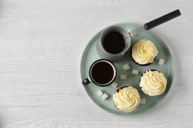 Beyaz masada sıcak kahve ile lezzetli çikolata cupcakes