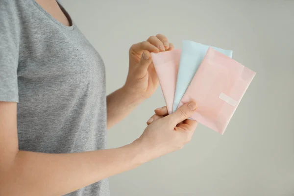 Woman Holding Menstrual Pads Grey Background — Stock Photo, Image