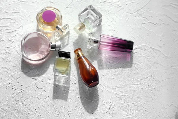 Different Bottles Perfume White Textured Background — Stock Photo, Image