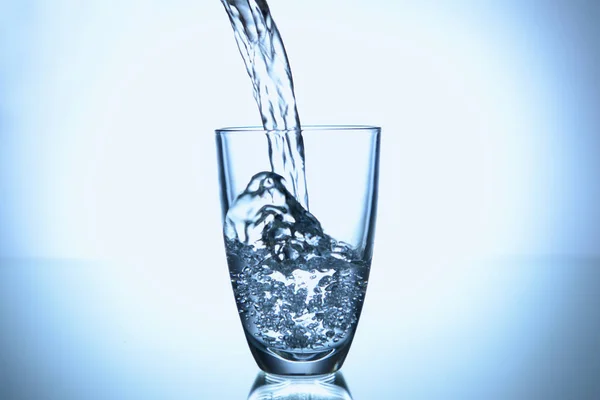 Pouring Water Glass Light Background — Stock Photo, Image