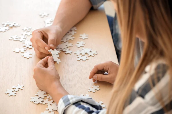 Young People Assembling Puzzle Wooden Table — Stock Photo, Image