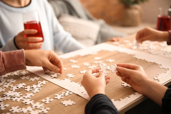 Group People Assembling Puzzle Wooden Table — Stock Photo, Image