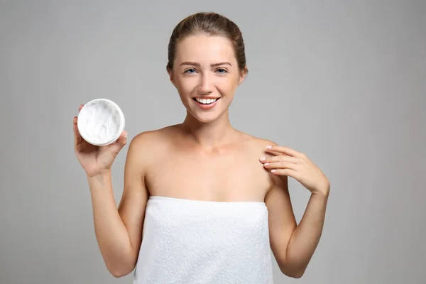 Beautiful Young Woman Wrapped Towel Holding Jar Cream Grey Background — Stock Photo, Image