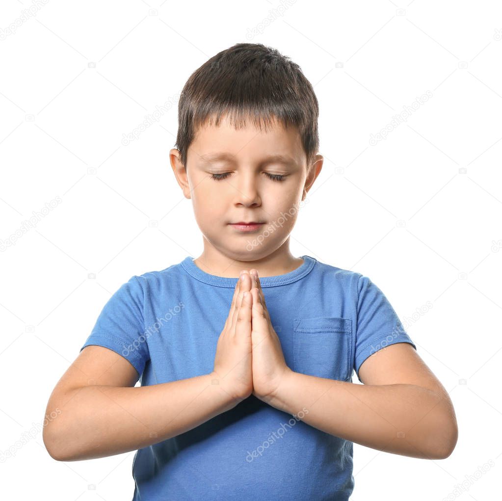 Little boy praying on white background